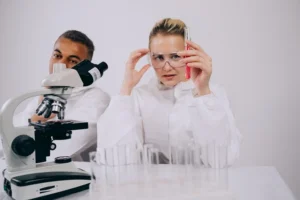 Two people in a lab with a microscope