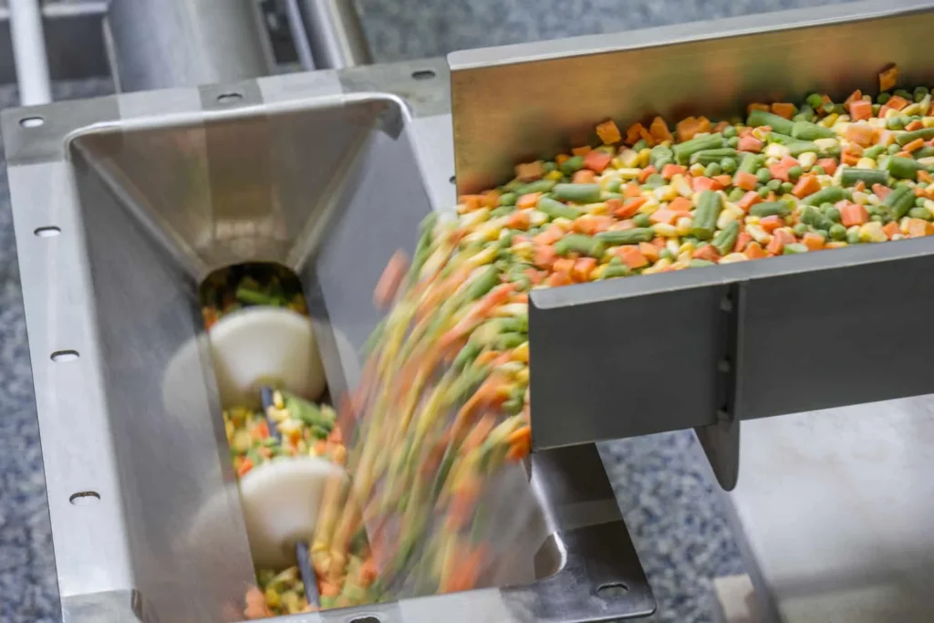 Frozen vegetables being processed on a conveyor system